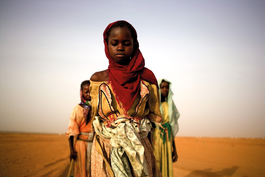 Young girls leave an IDP camp to gather firewood for their families. For some the work will take over 7 hours and lead them past government checkpoints and leave them exposed to attacks.